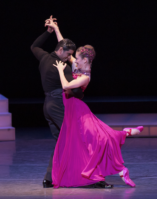 Rebecca Krohn in a fuchsia dress and pointe shoes. Amar Ramasar holds her in an embrace